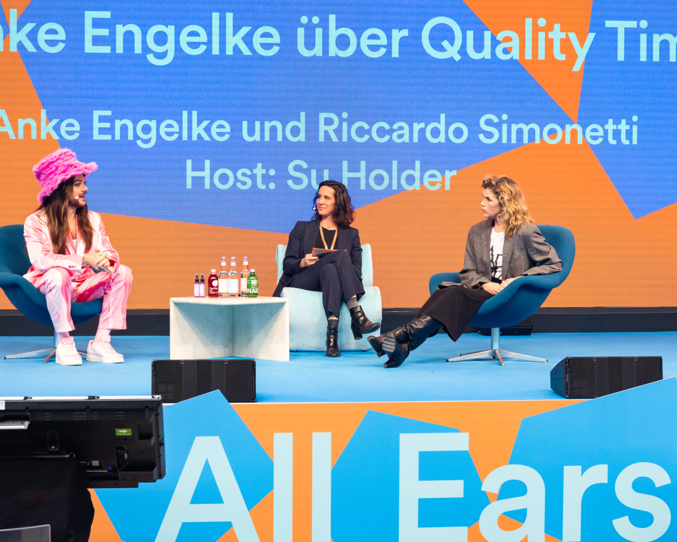 Stage of All Ears by Spotify, featuring hexagon shapes and a bold orange.