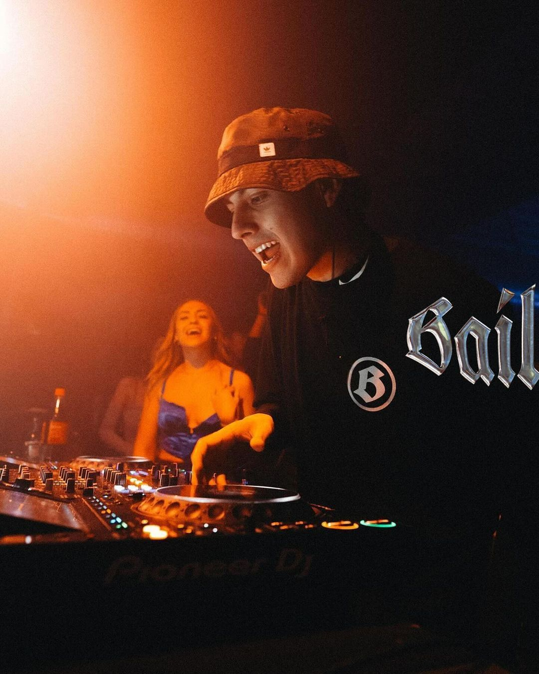 Photo of a Bailoteo DJ with half of the logo placed on it